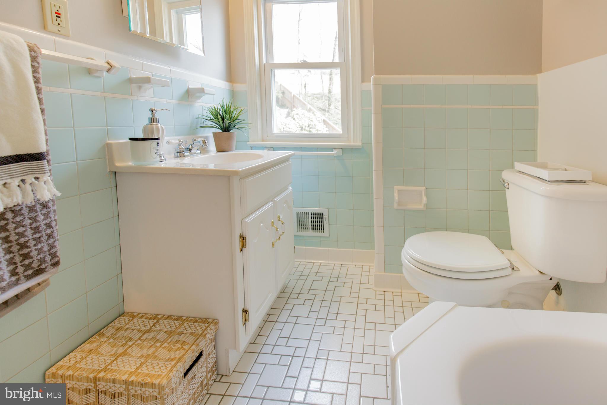 9601 Lorain Avenue Silver Spring, MD 20901 - Photo 21 of 30 a bathroom with a sink toilet and window