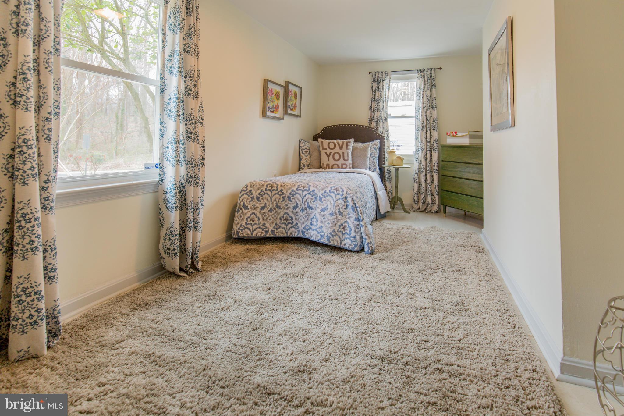 9601 Lorain Avenue Silver Spring, MD 20901 - Photo 28 of 30 a bedroom with a bed and a window