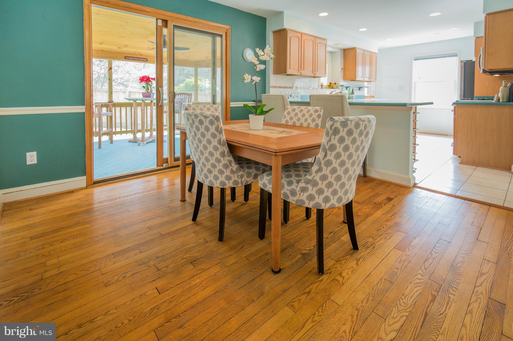 9601 Lorain Avenue Silver Spring, MD 20901 - Photo 8 of 30 a view of a dining room with furniture and wooden floor