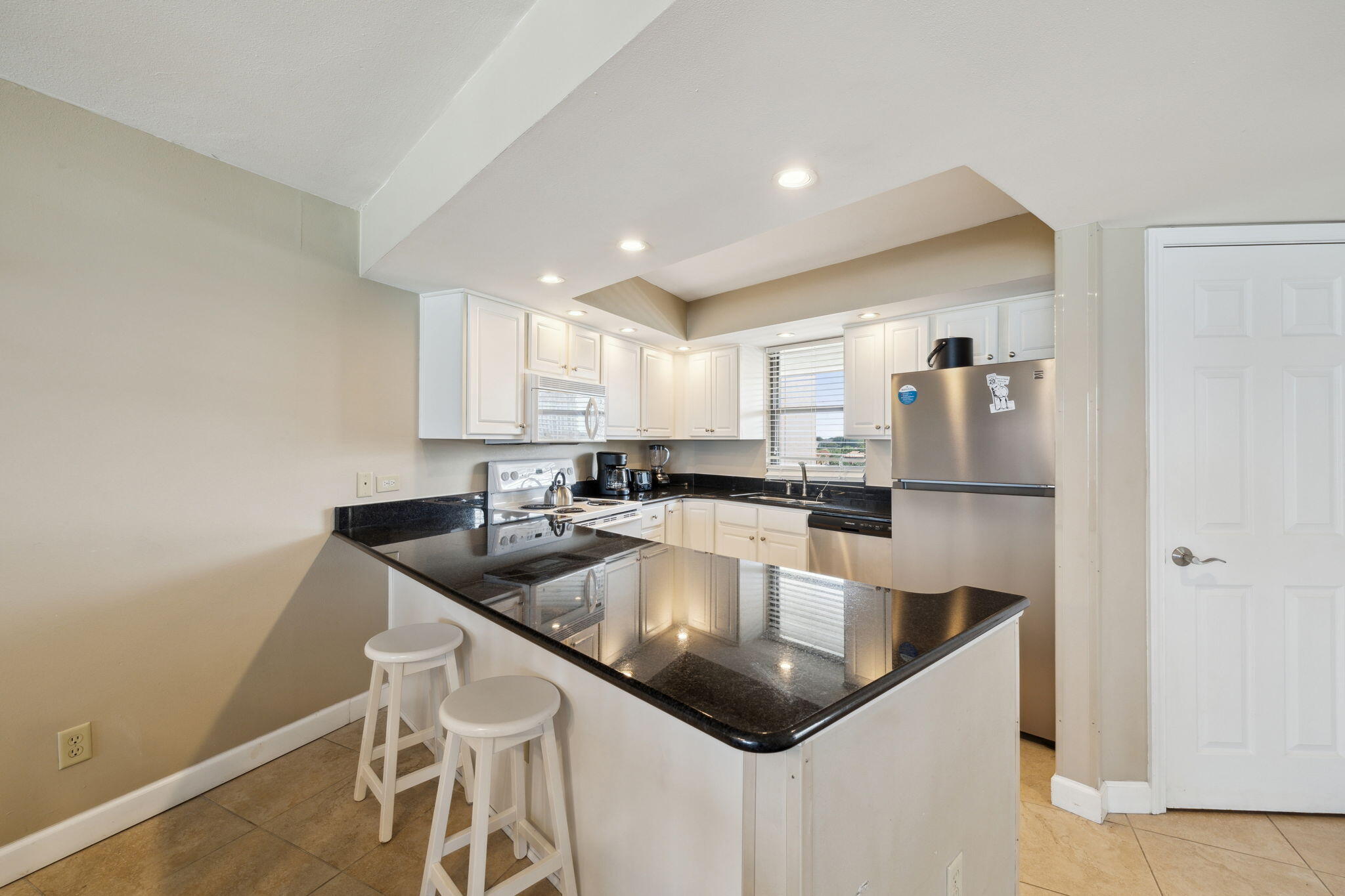 4072 Beachside 1, Unit 4072 Miramar Beach, FL 32550 - Photo 12 of 75 a kitchen with a sink a counter and cabinets