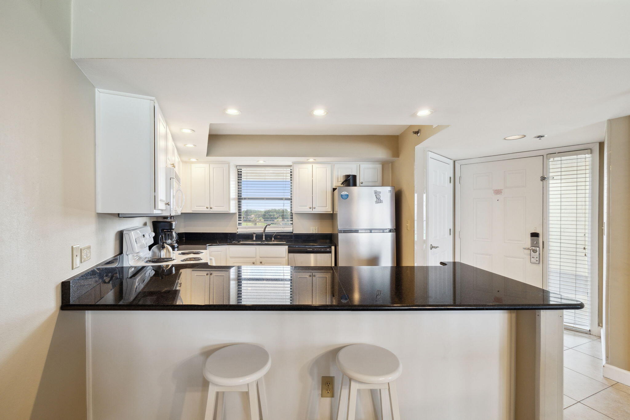 4072 Beachside 1, Unit 4072 Miramar Beach, FL 32550 - Photo 13 of 75 a kitchen with stainless steel appliances granite countertop a sink a stove and a refrigerator
