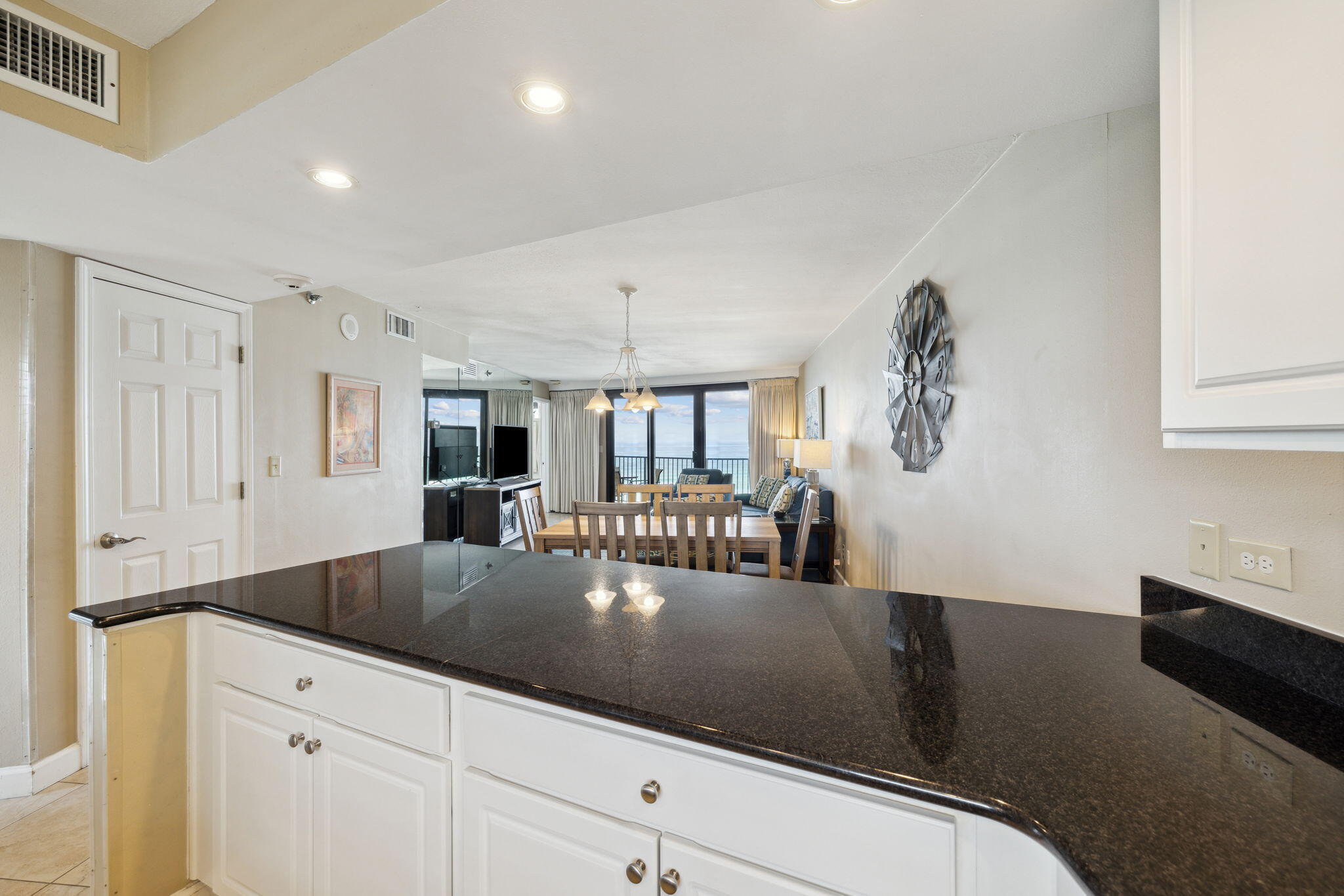 4072 Beachside 1, Unit 4072 Miramar Beach, FL 32550 - Photo 16 of 75 a kitchen with granite countertop a sink a stove and white cabinets