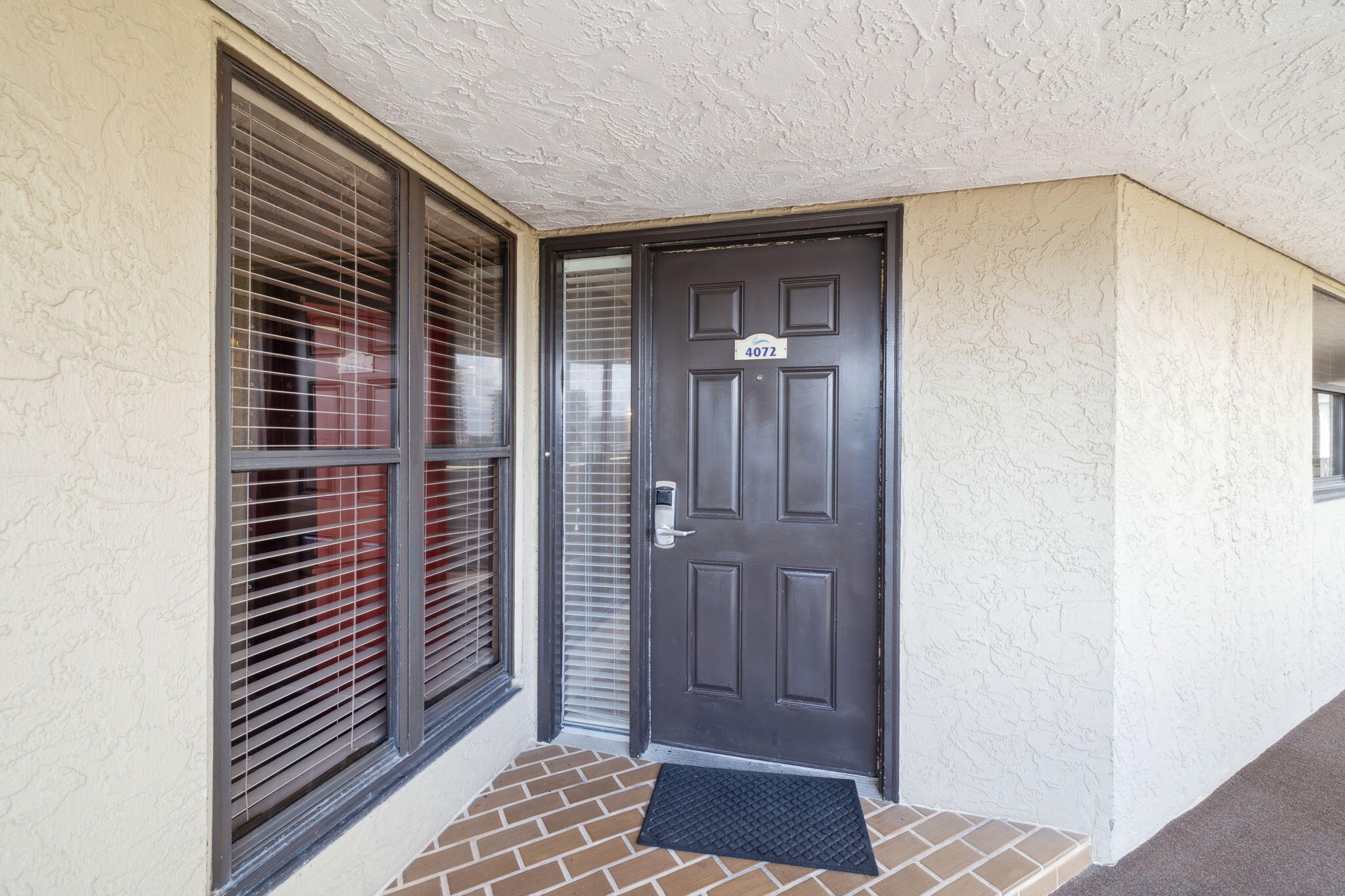 4072 Beachside 1, Unit 4072 Miramar Beach, FL 32550 - Photo 26 of 75 a view of a hallway with a door and bedroom