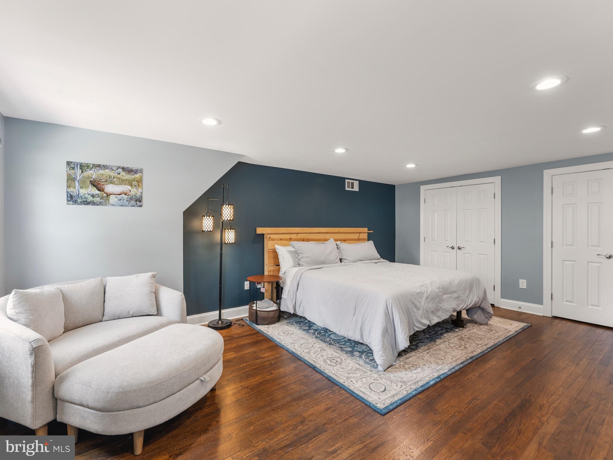 13744 Lockdale Road Silver Spring, MD 20906 - Photo 17 of 37 a spacious bedroom with a bed and a couch