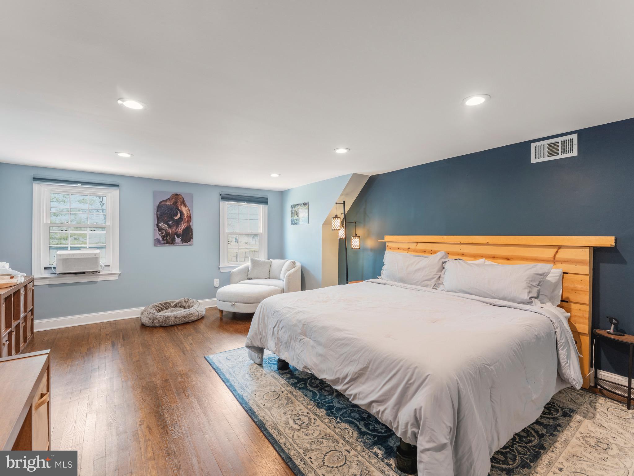 13744 Lockdale Road Silver Spring, MD 20906 - Photo 18 of 37 a spacious bedroom with a bed and wooden floor