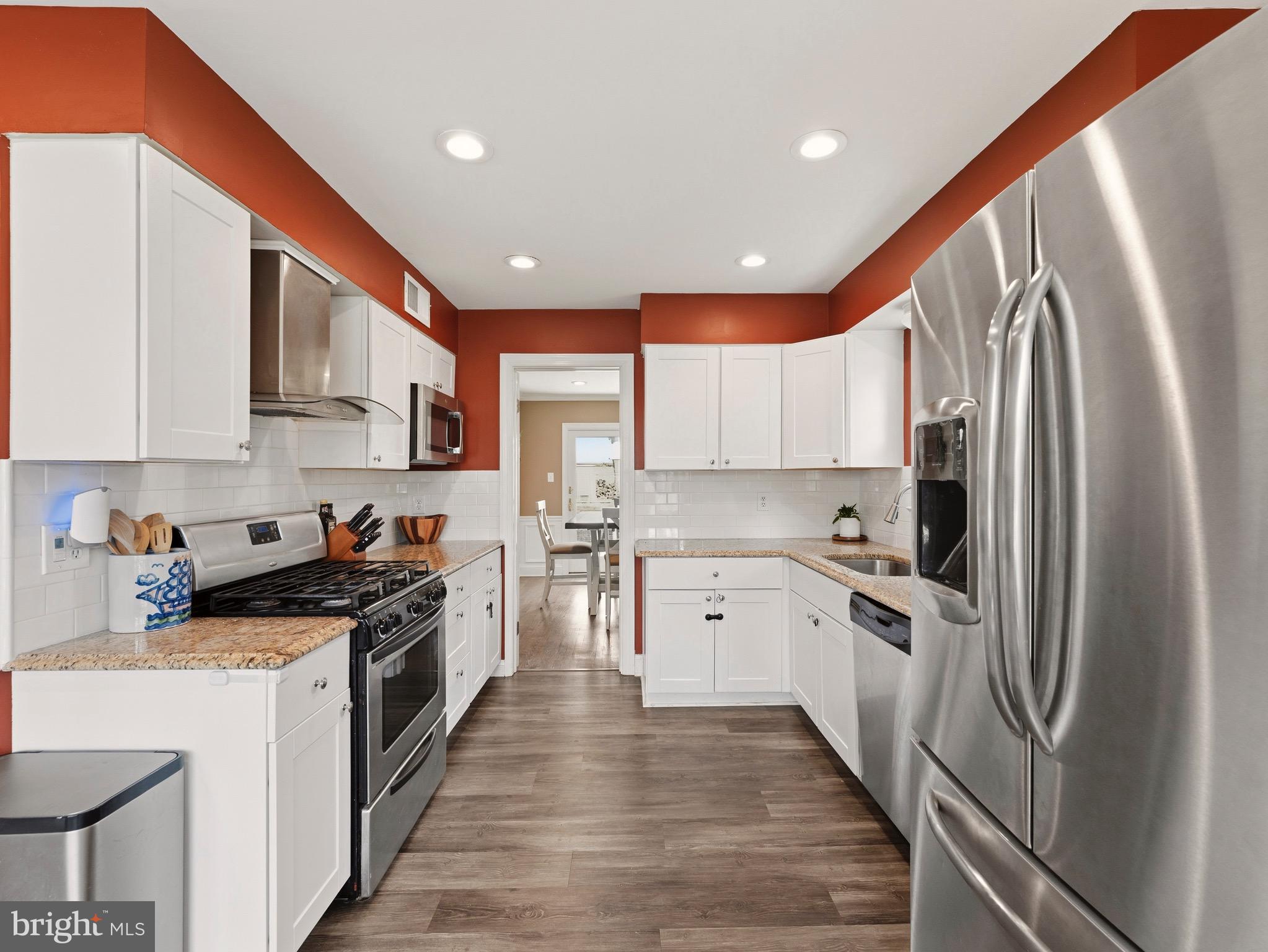 13744 Lockdale Road Silver Spring, MD 20906 - Photo 6 of 37 a kitchen with stainless steel appliances granite countertop a refrigerator a stove top oven a sink and dishwasher