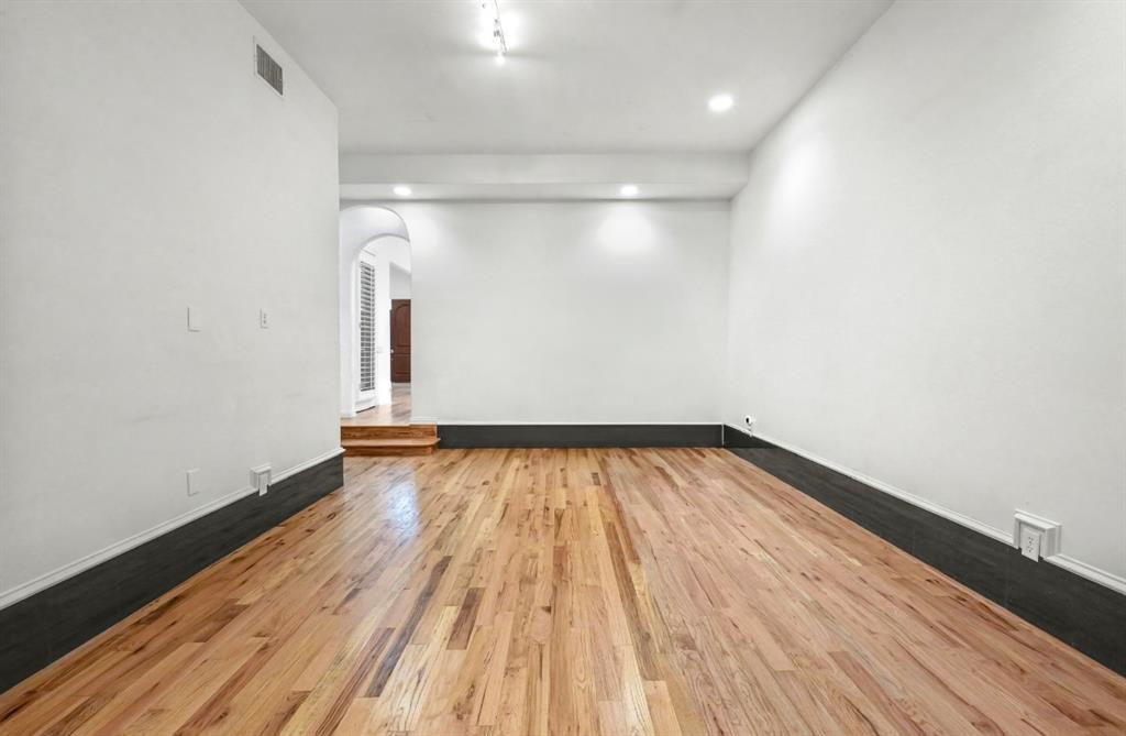 11911 Edgestone Road Dallas, TX 75230 - Photo 14 of 40 a view of empty room with wooden floor