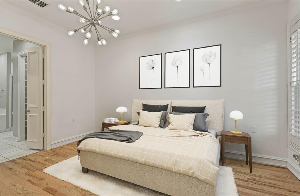 11911 Edgestone Road Dallas, TX 75230 - Photo 16 of 40 a bedroom with a bed and wooden floor