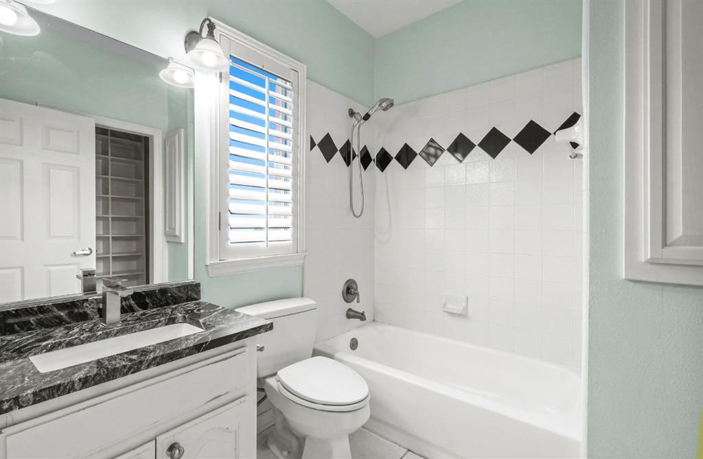 11911 Edgestone Road Dallas, TX 75230 - Photo 28 of 40 a bathroom with a granite countertop sink mirror toilet and bathtub