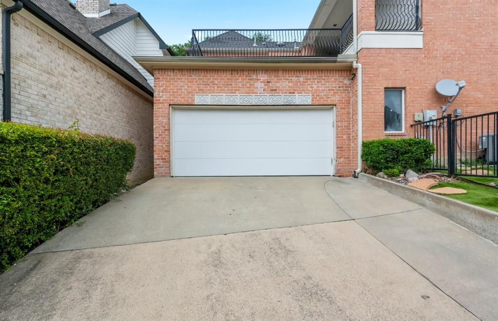11911 Edgestone Road Dallas, TX 75230 - Photo 35 of 40 Garage featuring driveway