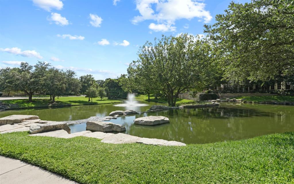 11911 Edgestone Road Dallas, TX 75230 - Photo 39 of 40 a view of a lake with houses in the back