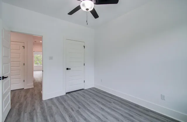 a view of an empty room and wooden floor