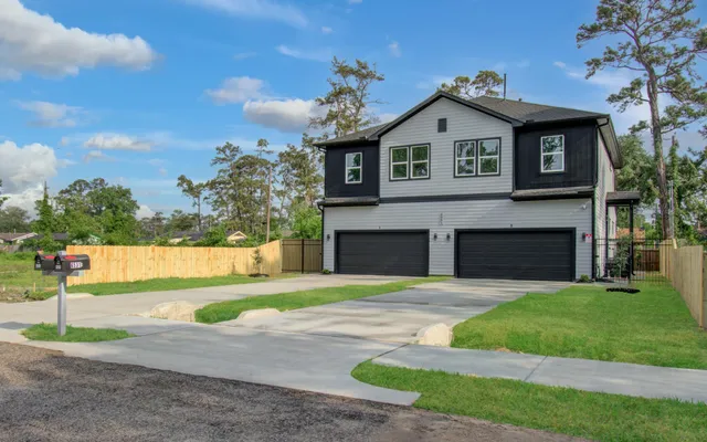 a front view of a house with a garden and yard