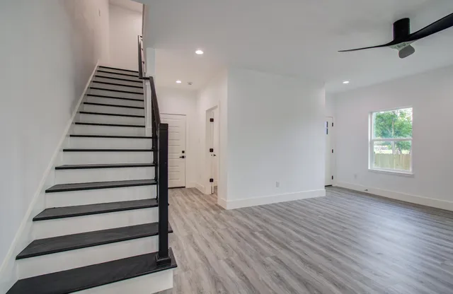 a view of an entryway with wooden floor