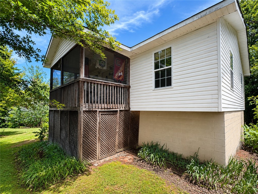 138 Cloverdale Road Seneca, SC 29678 - Photo 3 of 27 A charming screened porch extends from this inviting home, offering serene outdoor enjoyment.