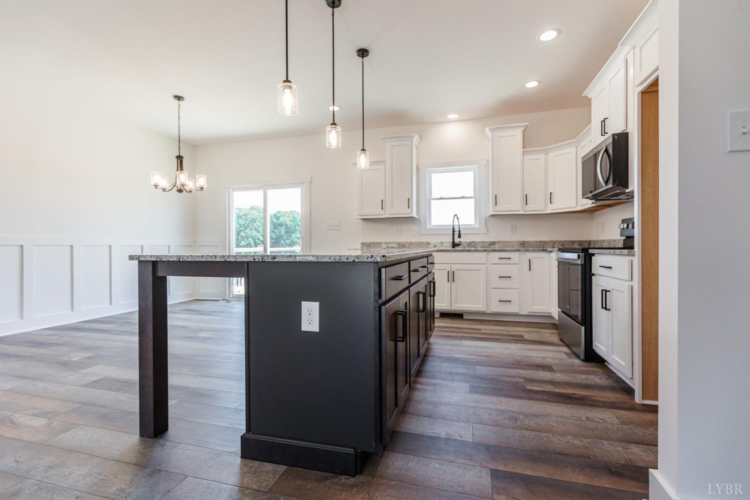 9740 Oakville Road Gladstone, VA 24553 - Photo 27 of 75 a kitchen with kitchen island a sink stainless steel appliances and cabinets