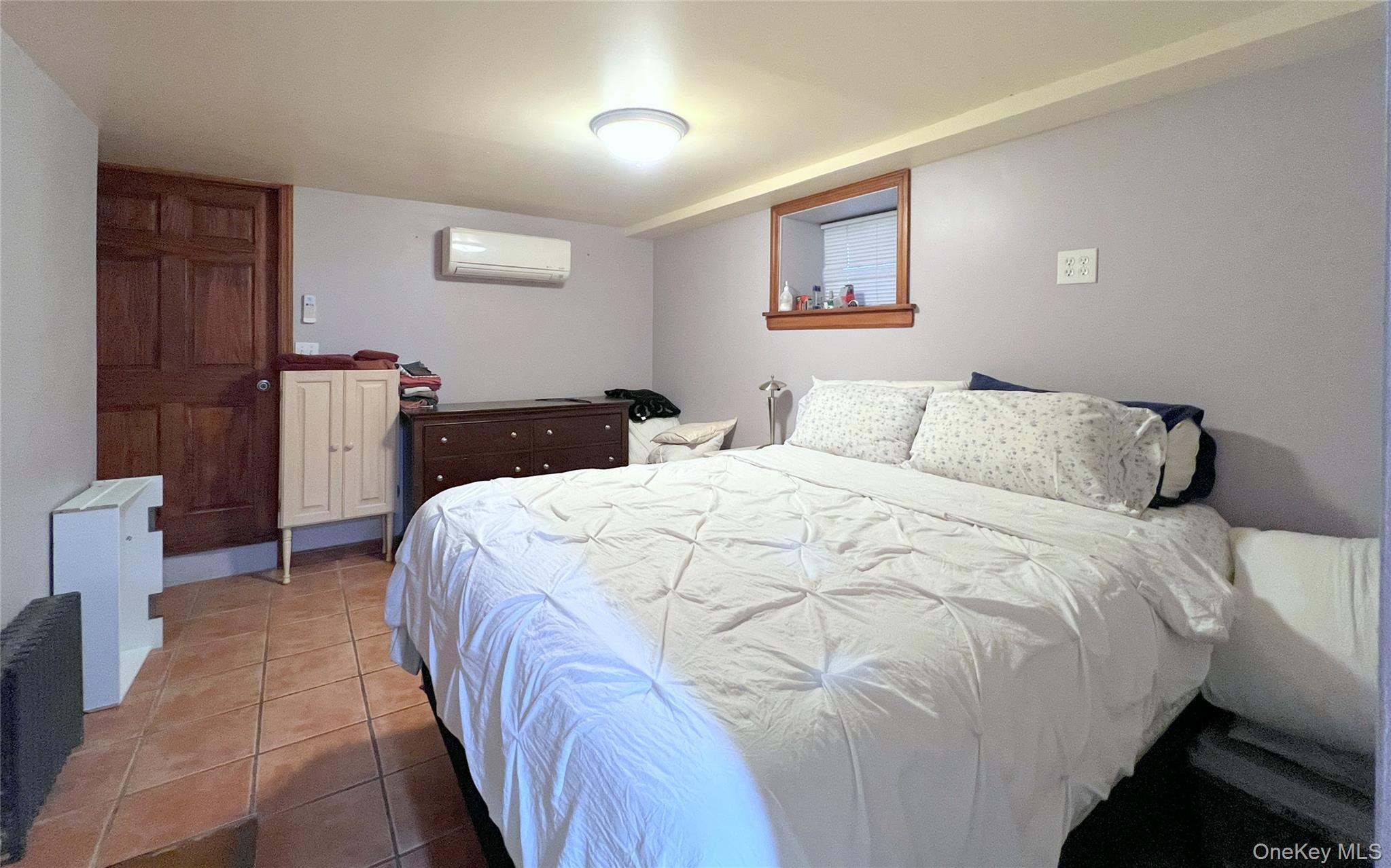 67-31 52nd Road Queens, NY 11378 - Photo 15 of 21 Tiled bedroom featuring a wall mounted AC