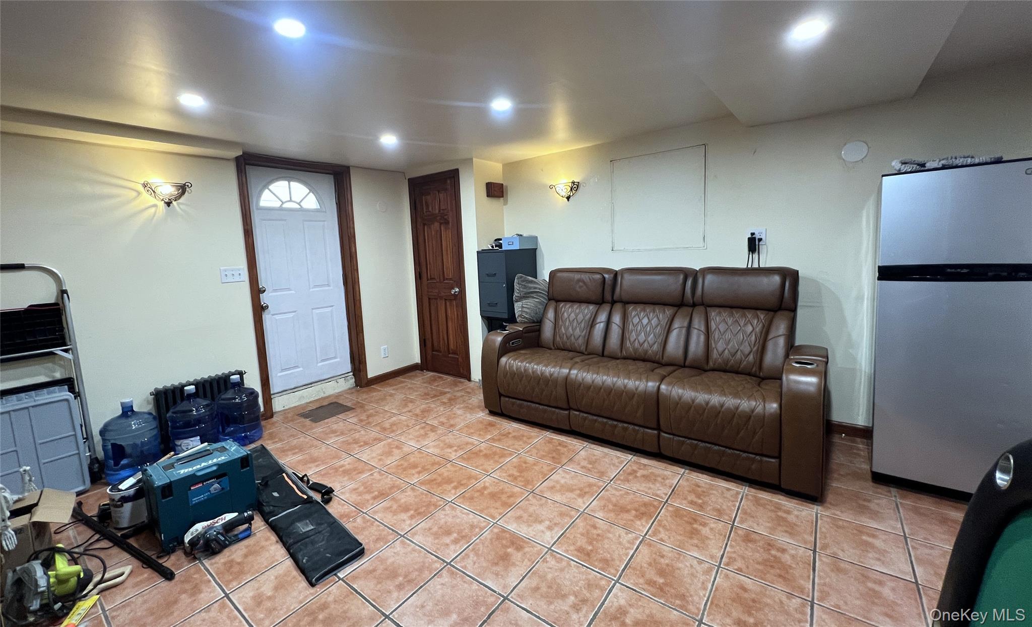 67-31 52nd Road Queens, NY 11378 - Photo 16 of 21 Living room featuring light tile patterned floors and recessed lighting