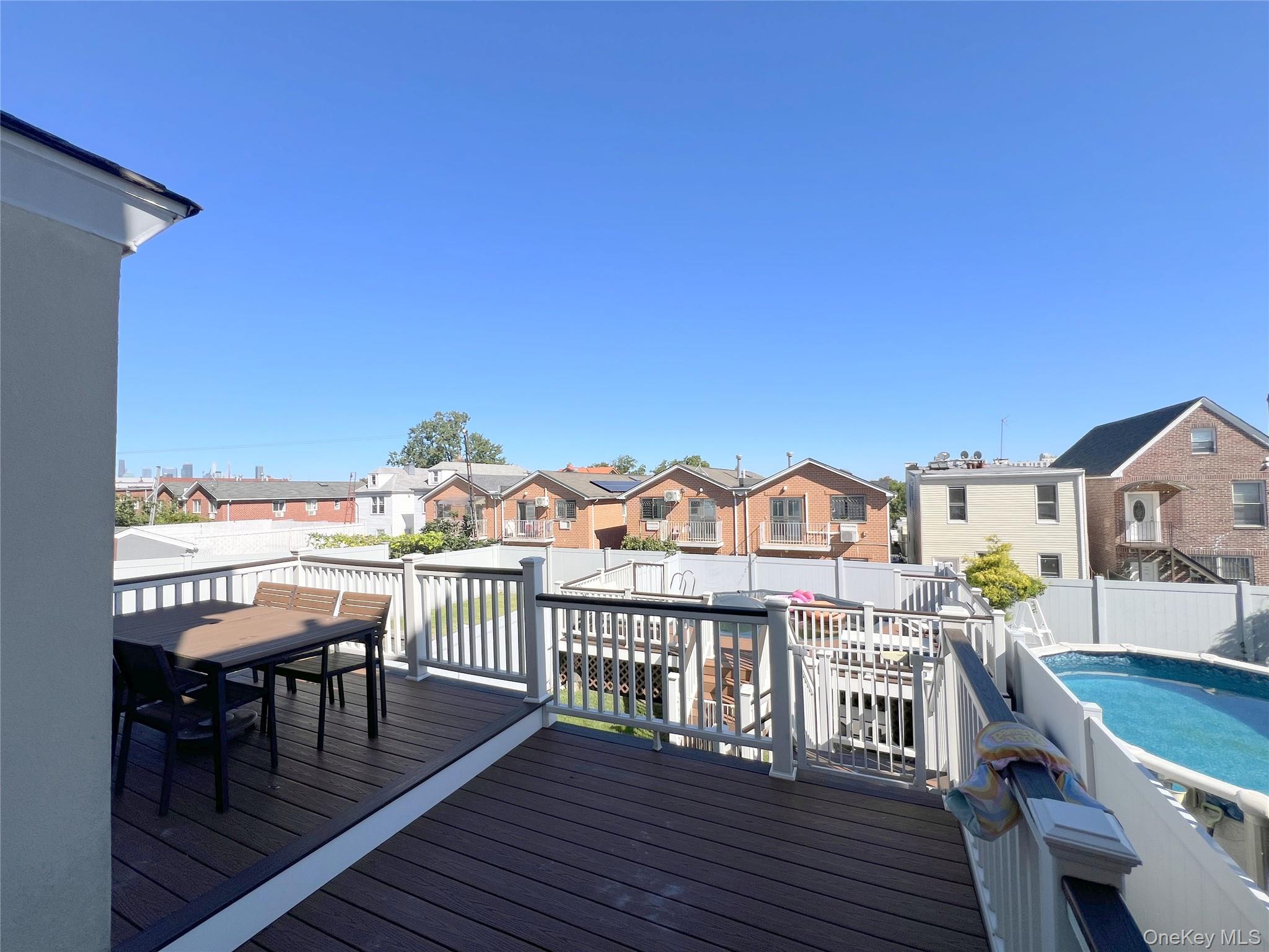 67-31 52nd Road Queens, NY 11378 - Photo 18 of 21 Deck featuring a residential view, outdoor dining space, and a fenced backyard