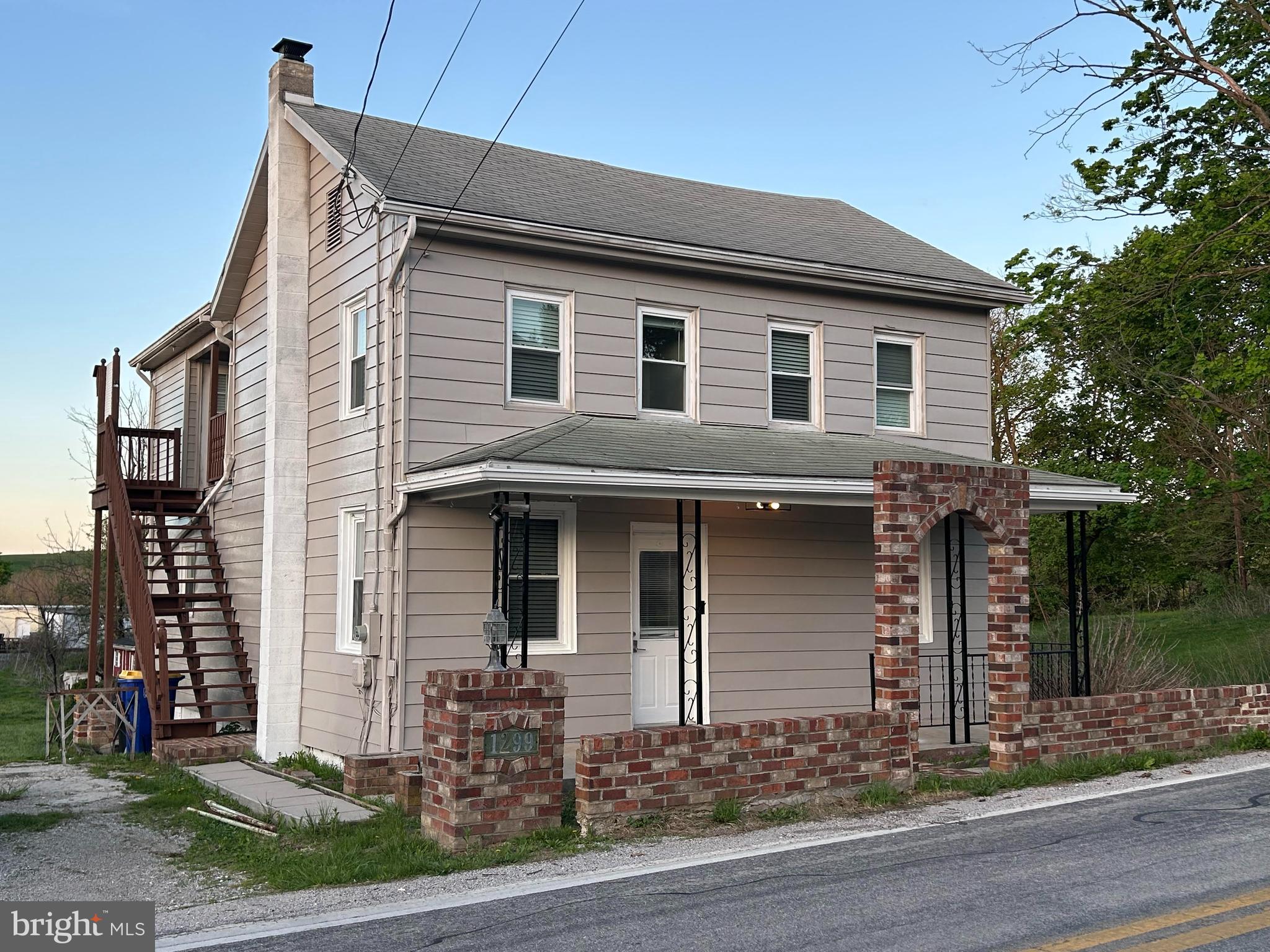 1299 Porters Road Spring Grove, PA 17362 - Photo 1 of 21 a front view of a house with garden