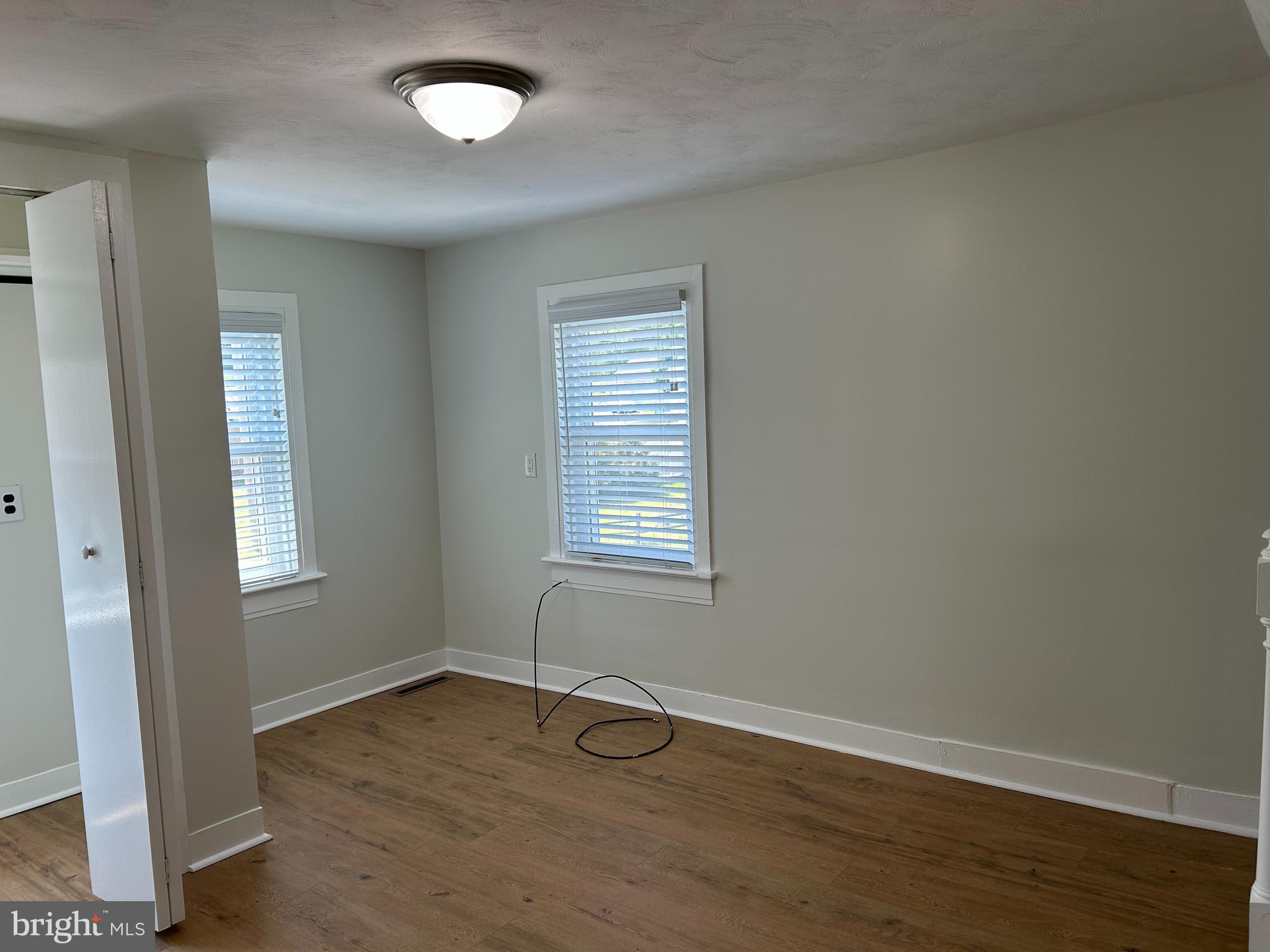 1299 Porters Road Spring Grove, PA 17362 - Photo 15 of 21 an empty room with wooden floor and windows
