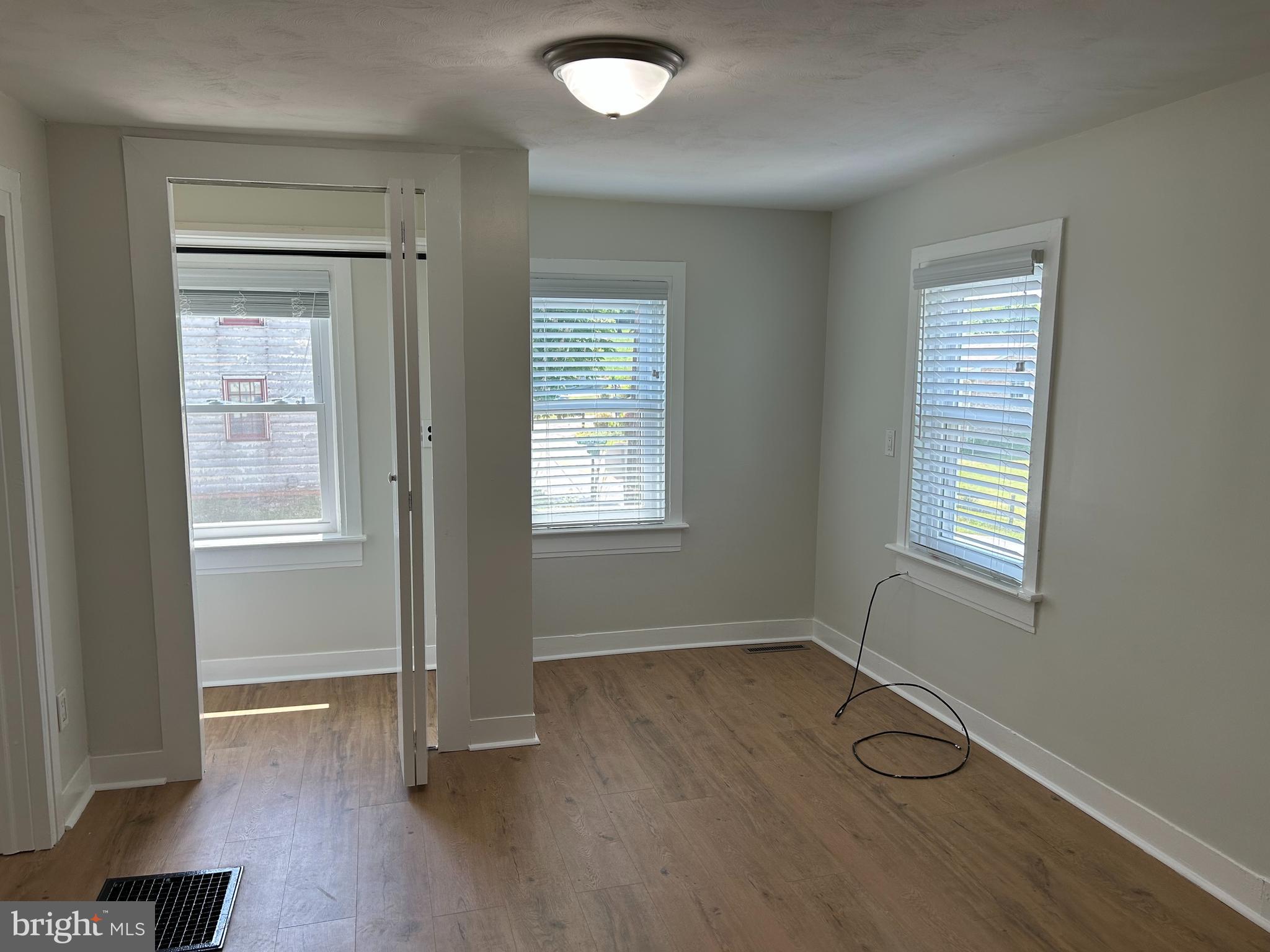 1299 Porters Road Spring Grove, PA 17362 - Photo 16 of 21 an empty room with wooden floor and windows