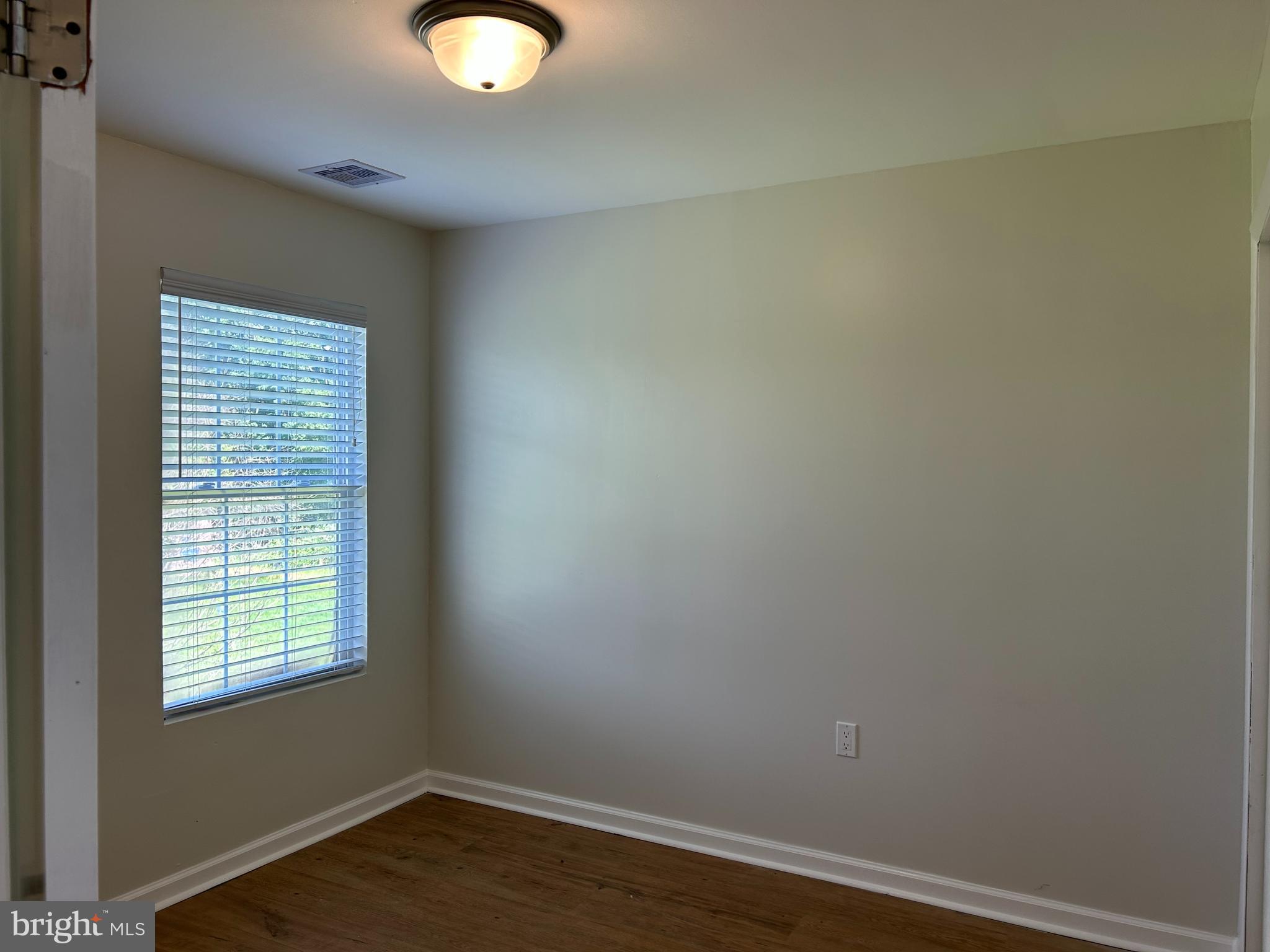 1299 Porters Road Spring Grove, PA 17362 - Photo 17 of 21 an empty room with wooden floor and windows