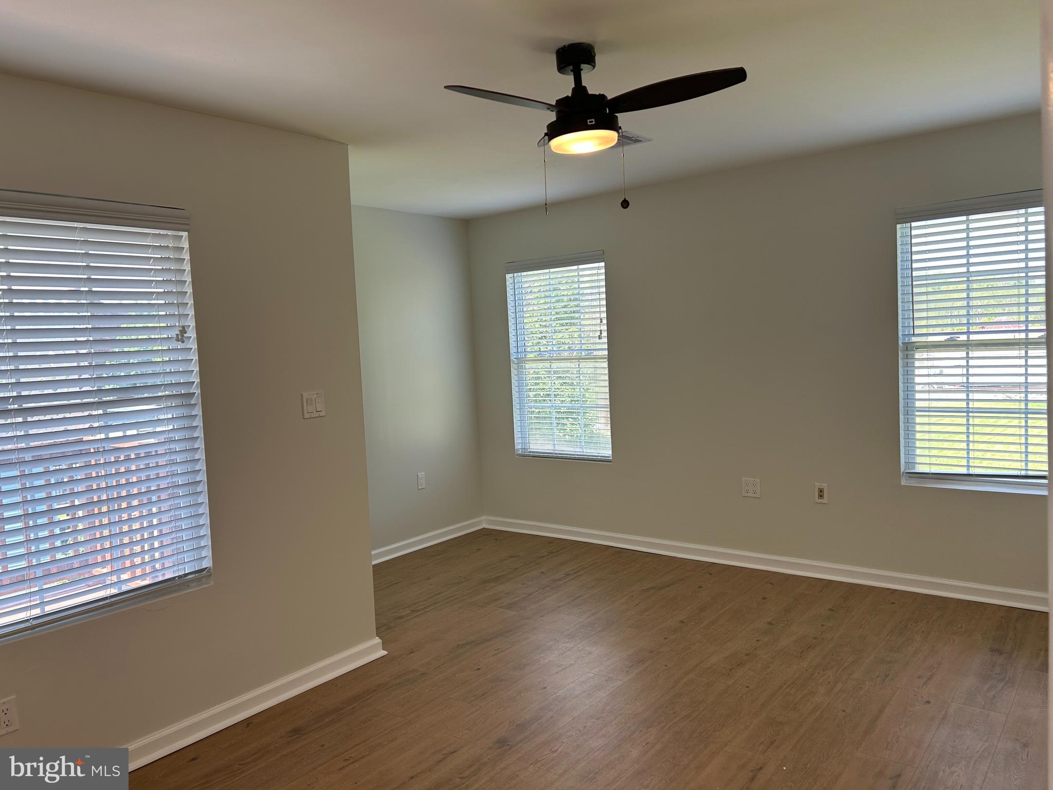 1299 Porters Road Spring Grove, PA 17362 - Photo 19 of 21 an empty room with wooden floor fan and windows