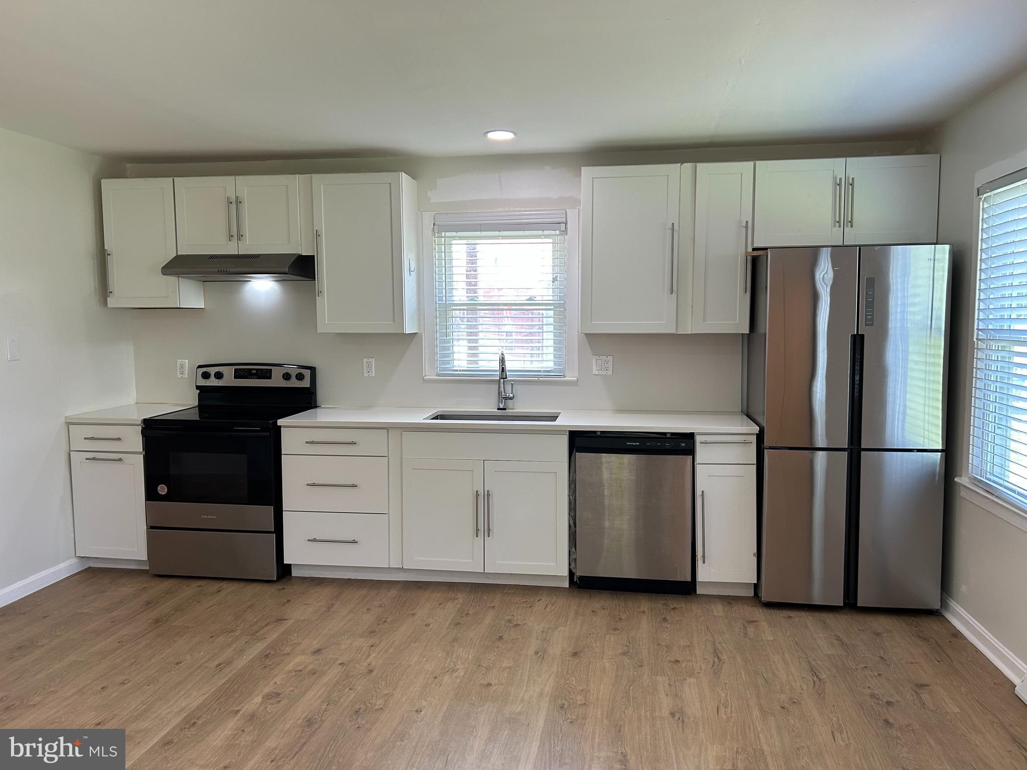 1299 Porters Road Spring Grove, PA 17362 - Photo 2 of 21 a kitchen with a refrigerator and a stove