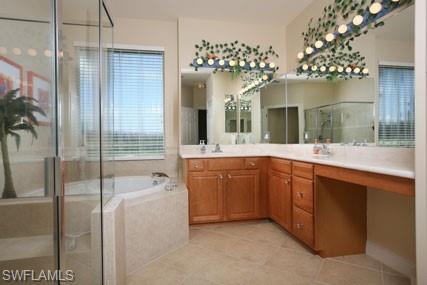 28605 San Lucas Lane, Unit 102 Bonita Springs, FL 34135 - Photo 11 of 20 a spacious bathroom with a double vanity sink a mirror and shower