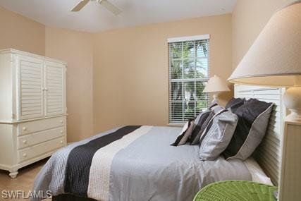 28605 San Lucas Lane, Unit 102 Bonita Springs, FL 34135 - Photo 12 of 20 a bed sitting in a bedroom next to a window