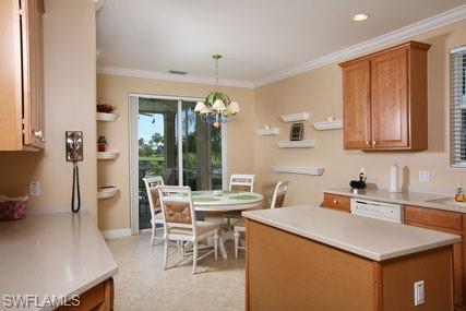 28605 San Lucas Lane, Unit 102 Bonita Springs, FL 34135 - Photo 5 of 20 a kitchen with a table chairs and a refrigerator