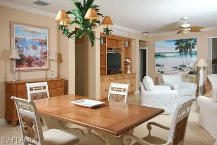 a dining room with furniture a window and chandelier
