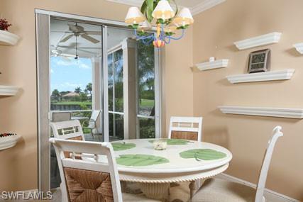 28605 San Lucas Lane, Unit 102 Bonita Springs, FL 34135 - Photo 9 of 20 a dining room with furniture a window and chandelier