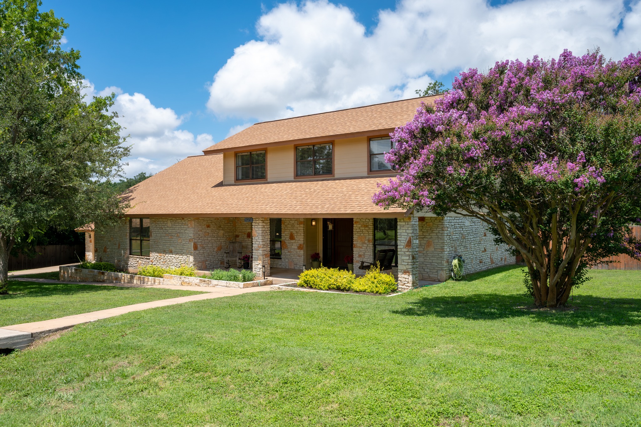 3908 Valley View Round Rock, TX 78681 - Photo 6 of 39 Well manicured lawn, blooming crepe myrtle, and that warm stone exterior give this home instant personality.