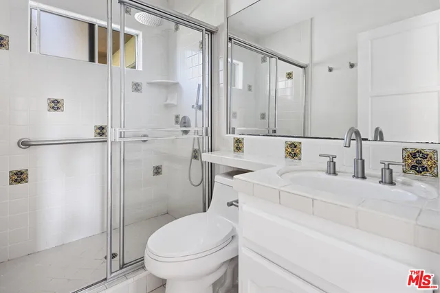 a kitchen with stainless steel appliances a refrigerator and wooden floor