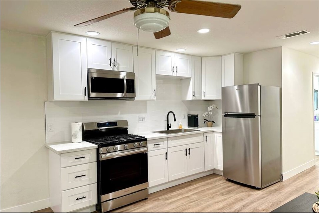 425 Lewis Place Placentia, CA 92870 - Photo 8 of 18 a kitchen with stainless steel appliances a refrigerator sink and microwave