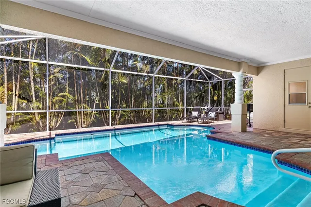 a view of a swimming pool with a lounge chair