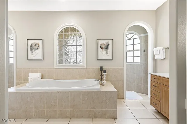 a bathroom with a bathtub and a window