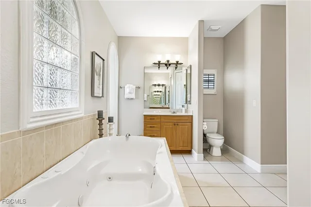 a bathroom with a sink a toilet a mirror and shower