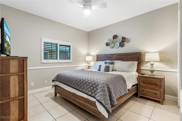 a bedroom with a bed and a refrigerator