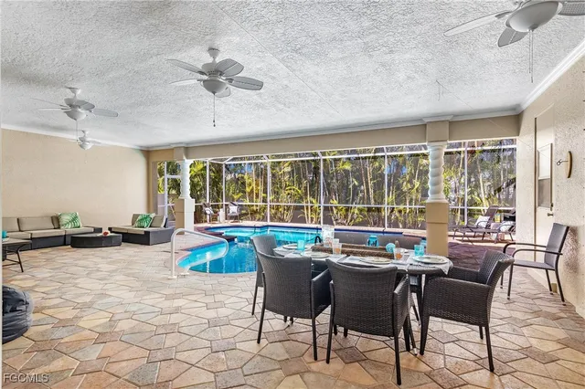 a dining room with furniture and large windows