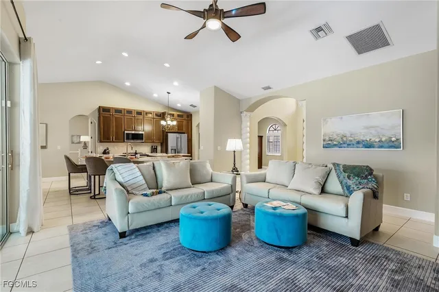 a kitchen with stainless steel appliances granite countertop a stove refrigerator sink and microwave