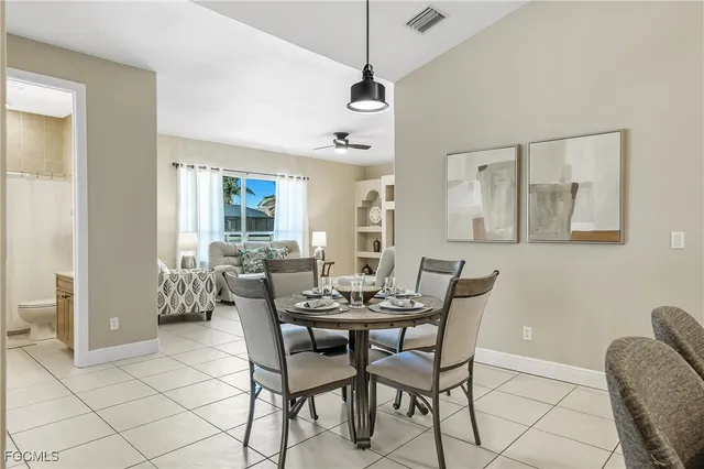 a living room with furniture and painting on the wall