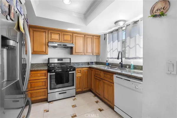 a kitchen with stainless steel appliances granite countertop a stove and a sink