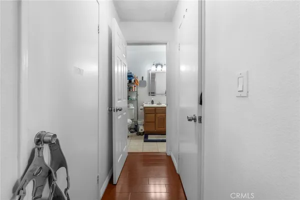 a view of a hallway with a livingroom and a bathroom with sink