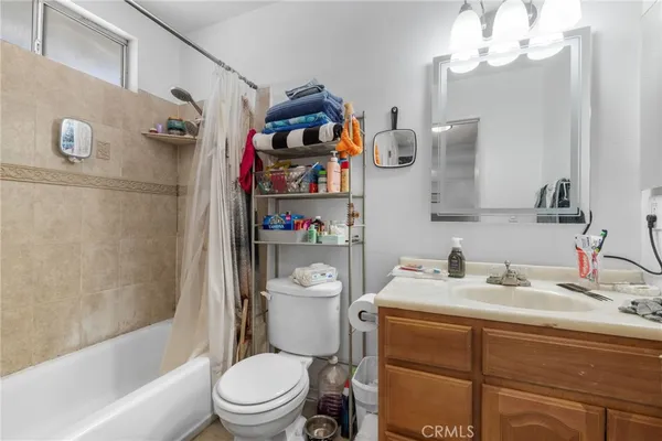 a bathroom with a sink a toilet and shower curtain