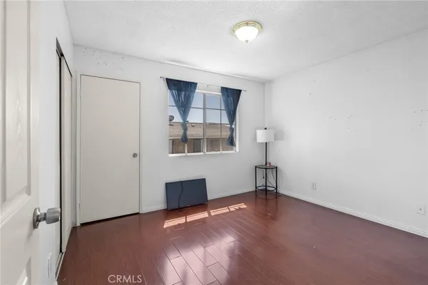 an empty room with windows and cabinet