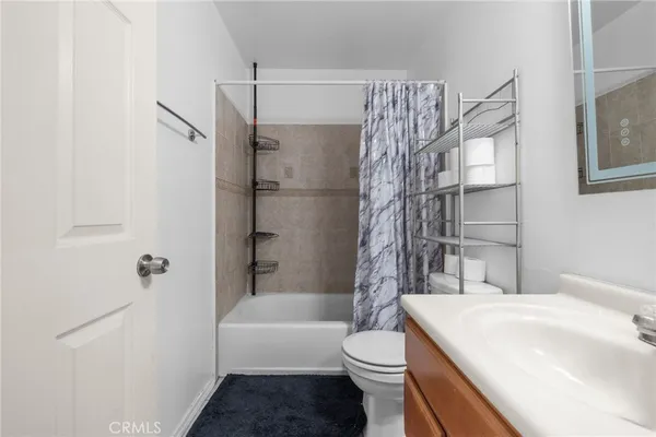 a bathroom with a toilet a sink and bathtub