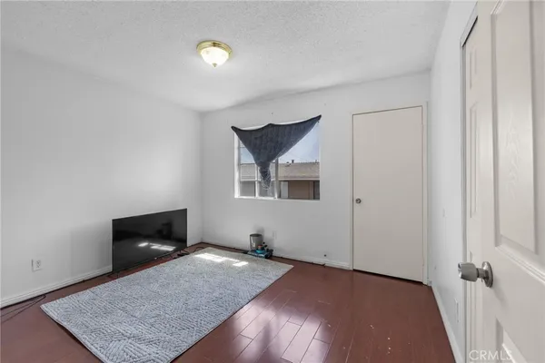 a bedroom with a bed and a rug